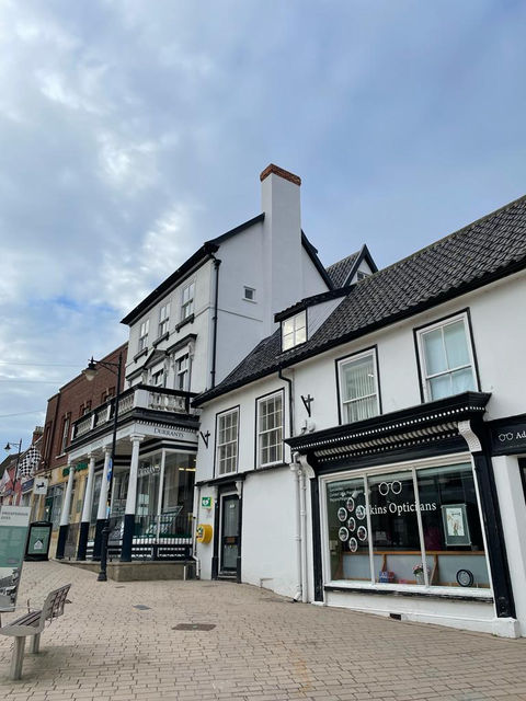 Listed building elevation in Diss before and during renovation
